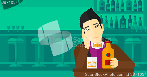 Image of Sad man with bottle and glass.