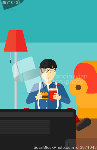 Image of Man eating hamburger. 
