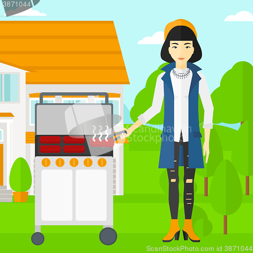 Image of Woman preparing barbecue.