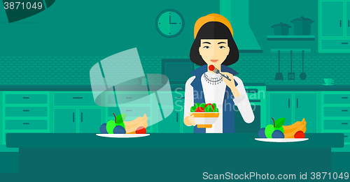 Image of Woman eating salad.