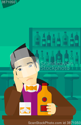 Image of Sad man with bottle and glass.