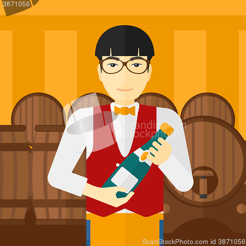 Image of Waiter holding bottle of wine.