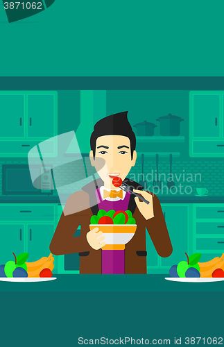 Image of Man eating salad.