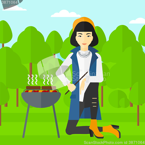 Image of Woman preparing barbecue.