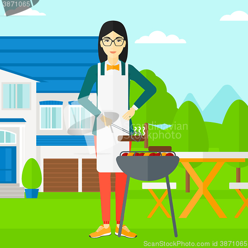 Image of Woman preparing barbecue.