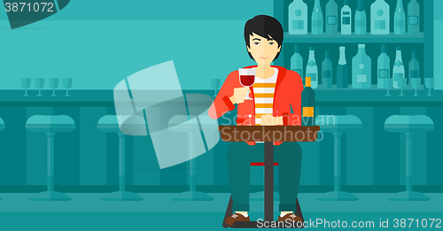 Image of Man sitting at bar.