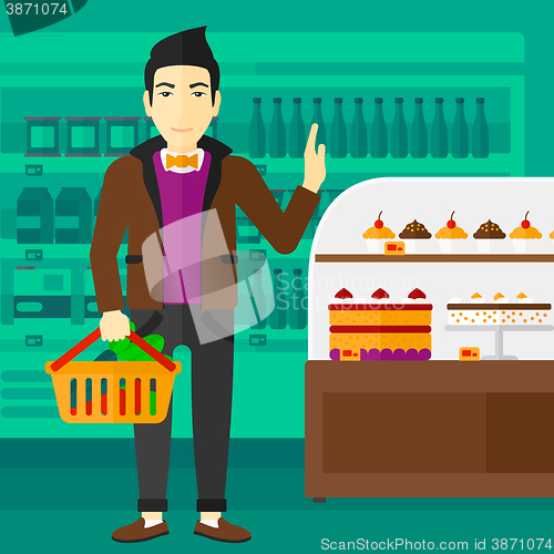 Image of Man holding supermarket basket.