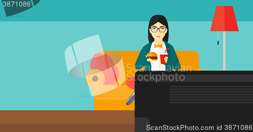 Image of Woman eating hamburger. 