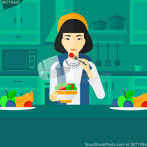 Image of Woman eating salad.