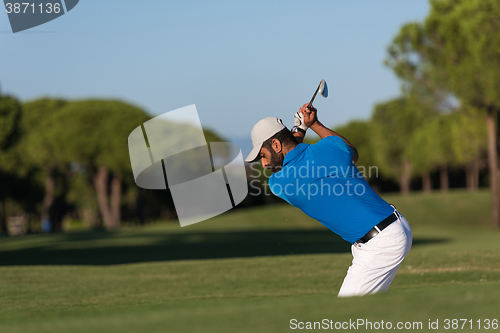 Image of pro golfer hitting a sand bunker shot