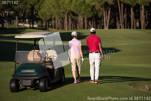 Image of couple walking on golf course