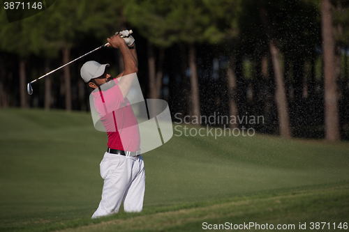 Image of golfer hitting a sand bunker shot