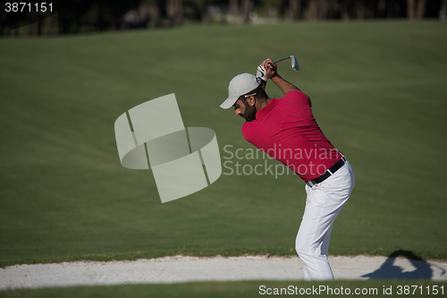 Image of golfer hitting a sand bunker shot