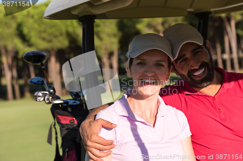 Image of couple in buggy on golf course