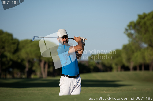 Image of pro golfer hitting a sand bunker shot