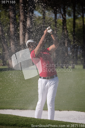 Image of golfer hitting a sand bunker shot