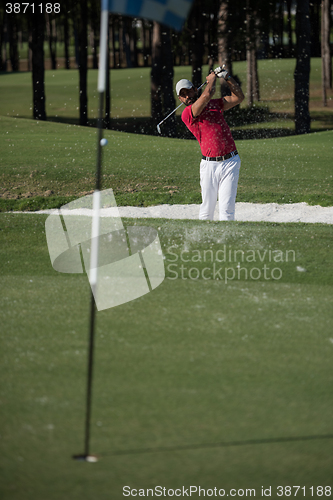 Image of golfer hitting a sand bunker shot