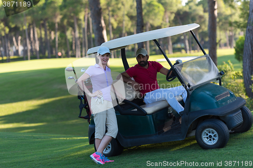 Image of couple in buggy on golf course