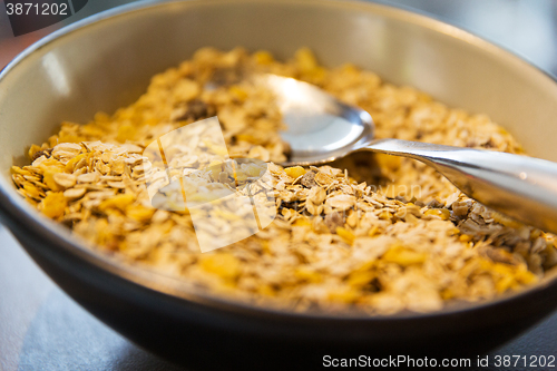 Image of close up of bowl with granola or muesli and spoon