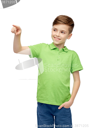 Image of happy boy in green polo t-shirt pointing finger up