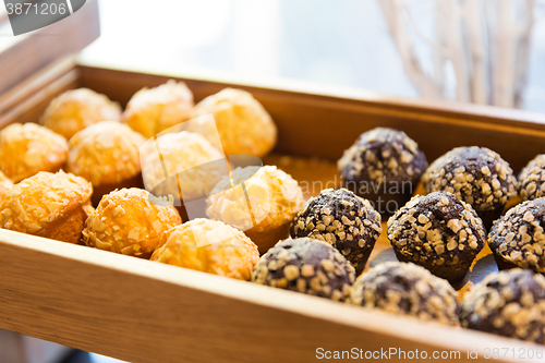 Image of close up of sweets or muffins on wooden tray