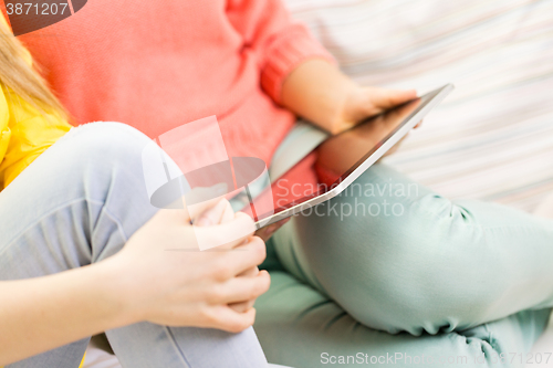 Image of close up of young women with tablet pc at home