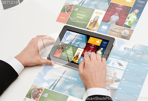 Image of close up of man hands with web pages on tablet pc