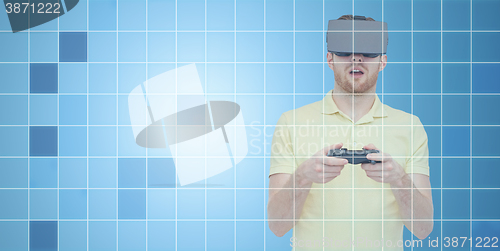 Image of man in virtual reality headset with gamepad