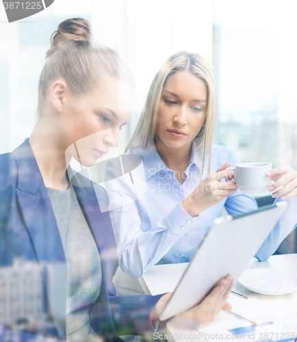 Image of business team with tablet pc having discussion