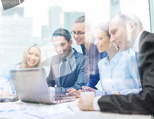 Image of business team with laptop having discussion