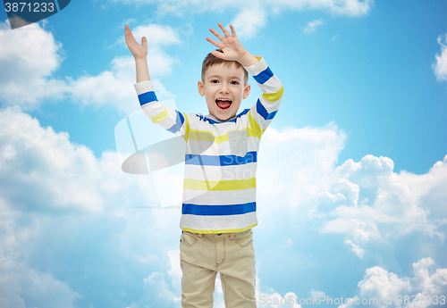 Image of happy little boy waving hands