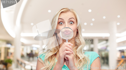 Image of happy young woman with magnifying glass