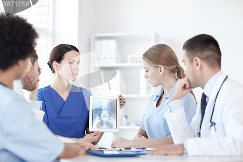 Image of group of doctors with x-ray on tablet pc at clinic