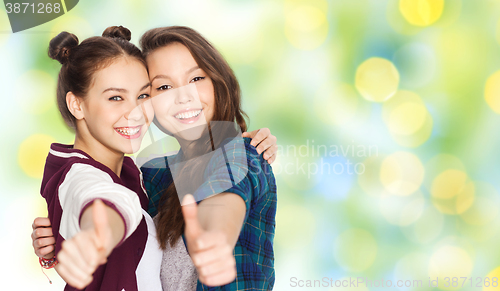 Image of happy smiling teenage girls showing thumbs up