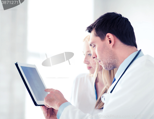 Image of two doctors looking at x-ray on tablet pc