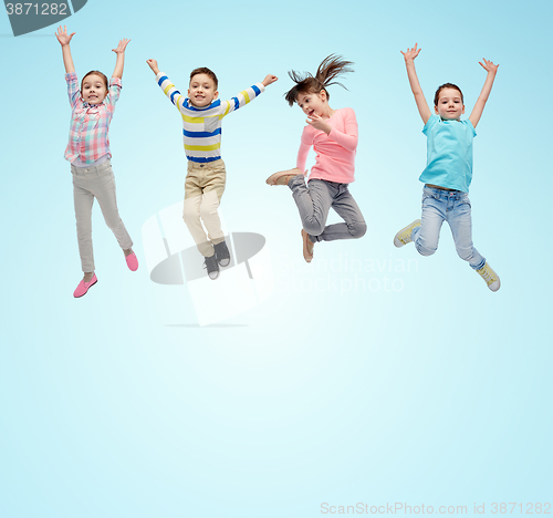 Image of happy little children jumping in air over blue