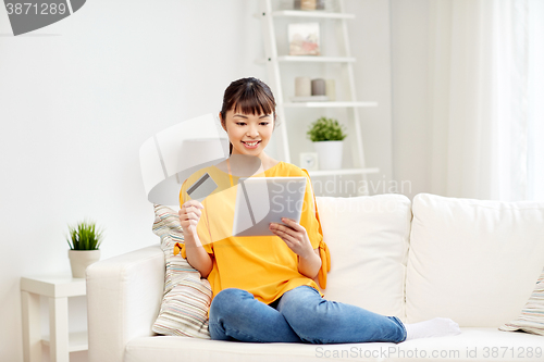 Image of happy asian woman with tablet pc and credit card