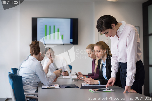 Image of young  woman using  tablet on business meeting