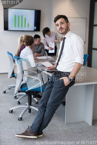 Image of young business man with tablet at office meeting room