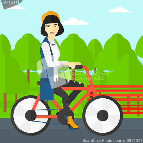 Image of Woman riding bicycle.