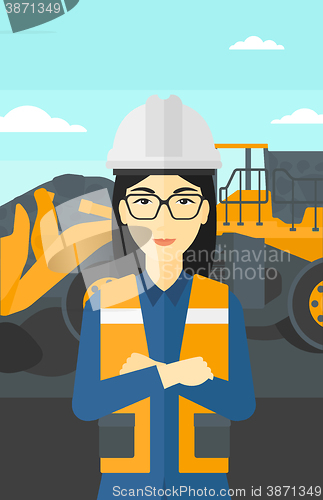 Image of Miner with mining equipment on background.