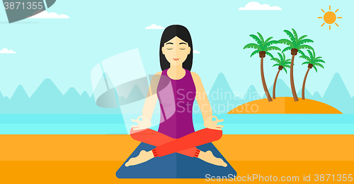 Image of Woman meditating in lotus pose.