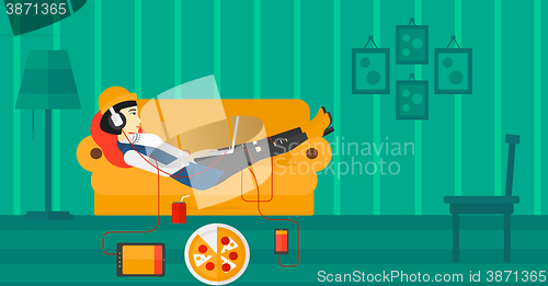 Image of Woman lying on sofa with many gadgets.