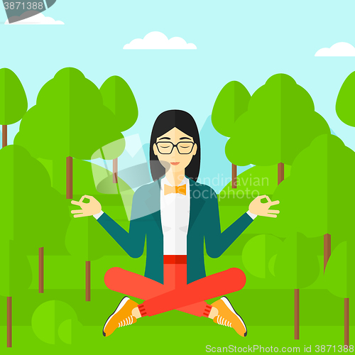 Image of Business woman meditating in lotus pose.