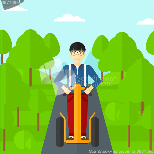 Image of Man riding on electric scooter.