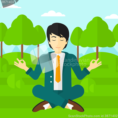 Image of Businessman meditating in lotus pose.