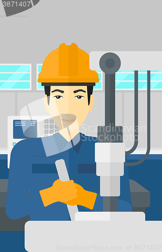 Image of Man working with industrial equipment.