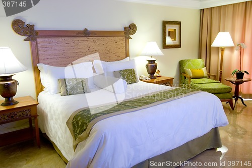 Image of King sized bed in a hotel suite room

