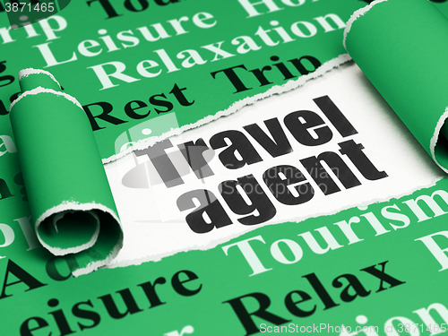 Image of Vacation concept: black text Travel Agent under the piece of  torn paper