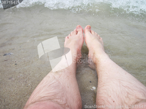 Image of man legs in the sea water